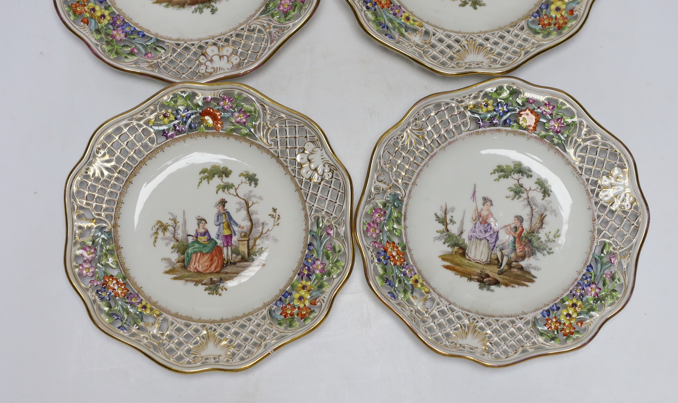 A set of four Dresden cabinet plates decorated with lovers, 22cm high